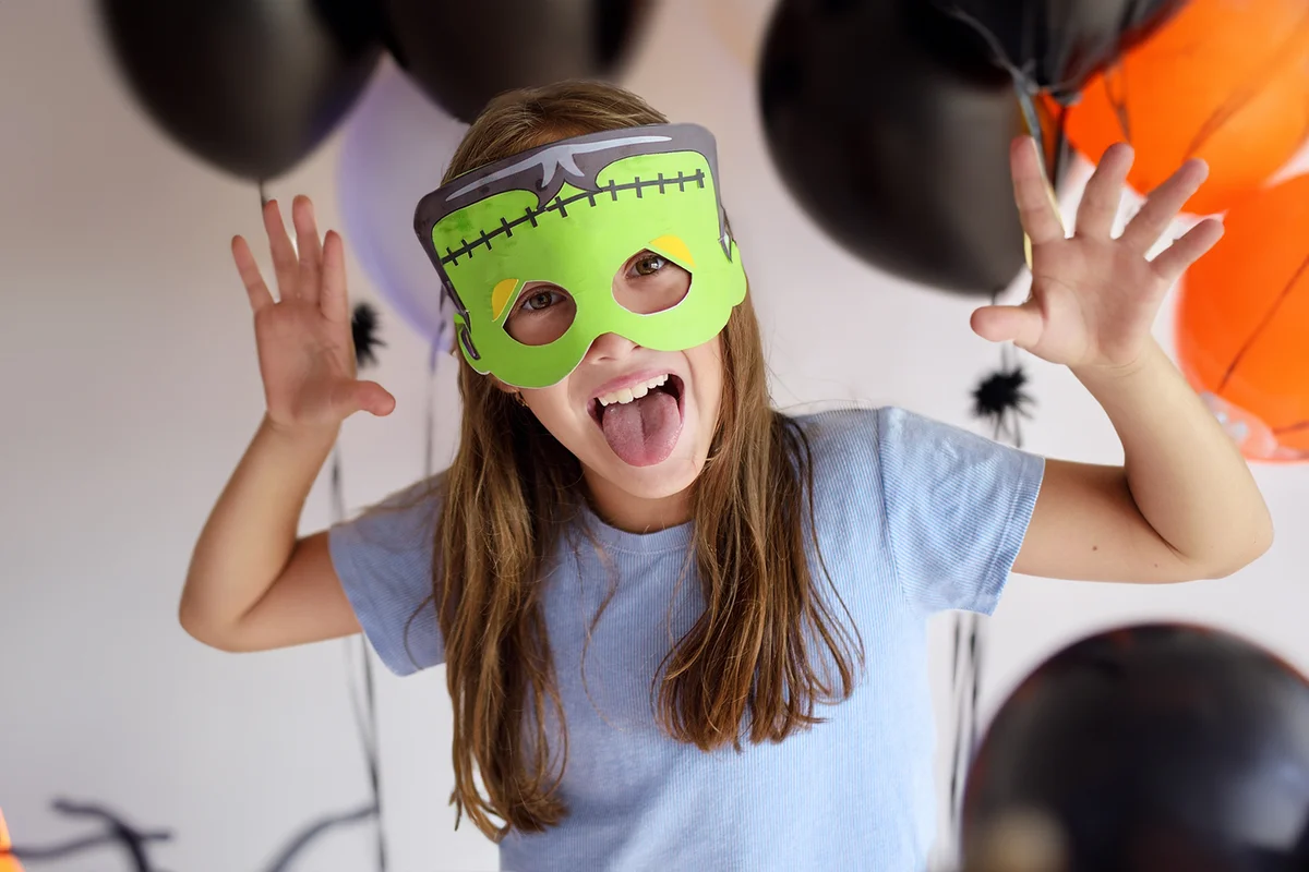 The girl plays in a self-made mask of Frankenstein for Halloween