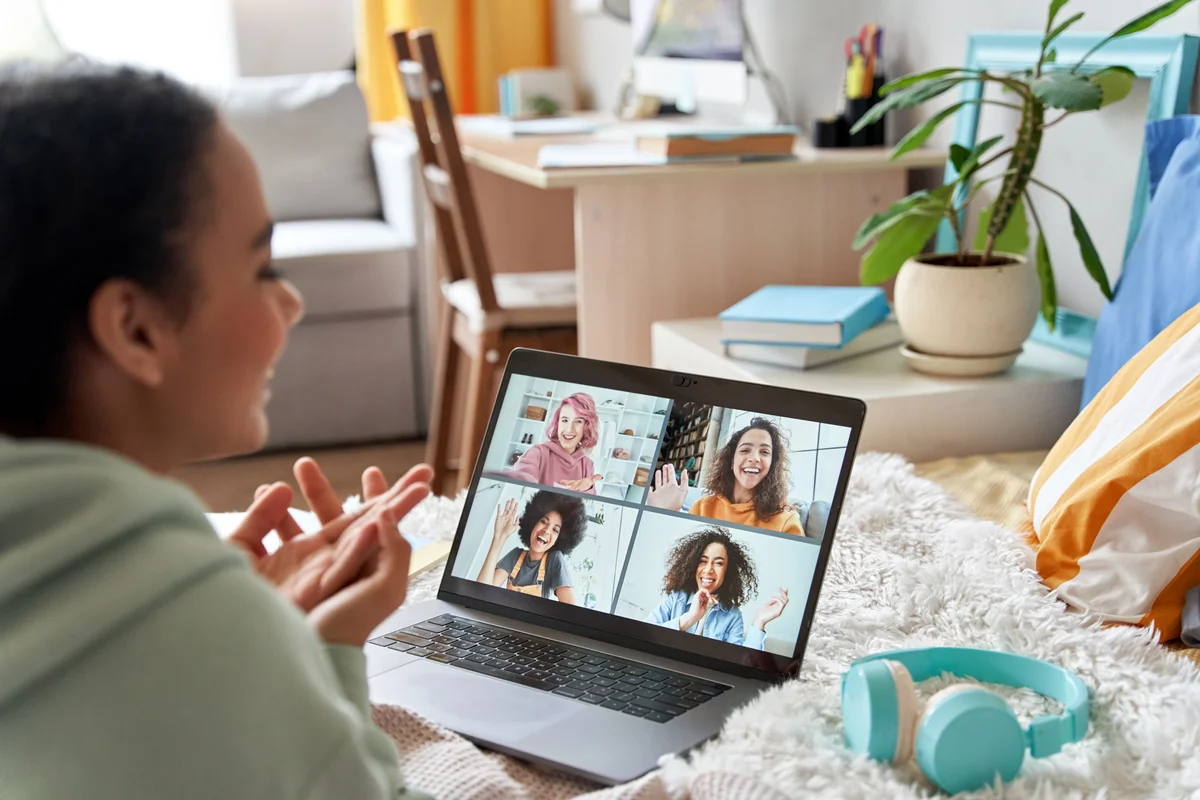 Teen girl talking with friends on distance video group conference call