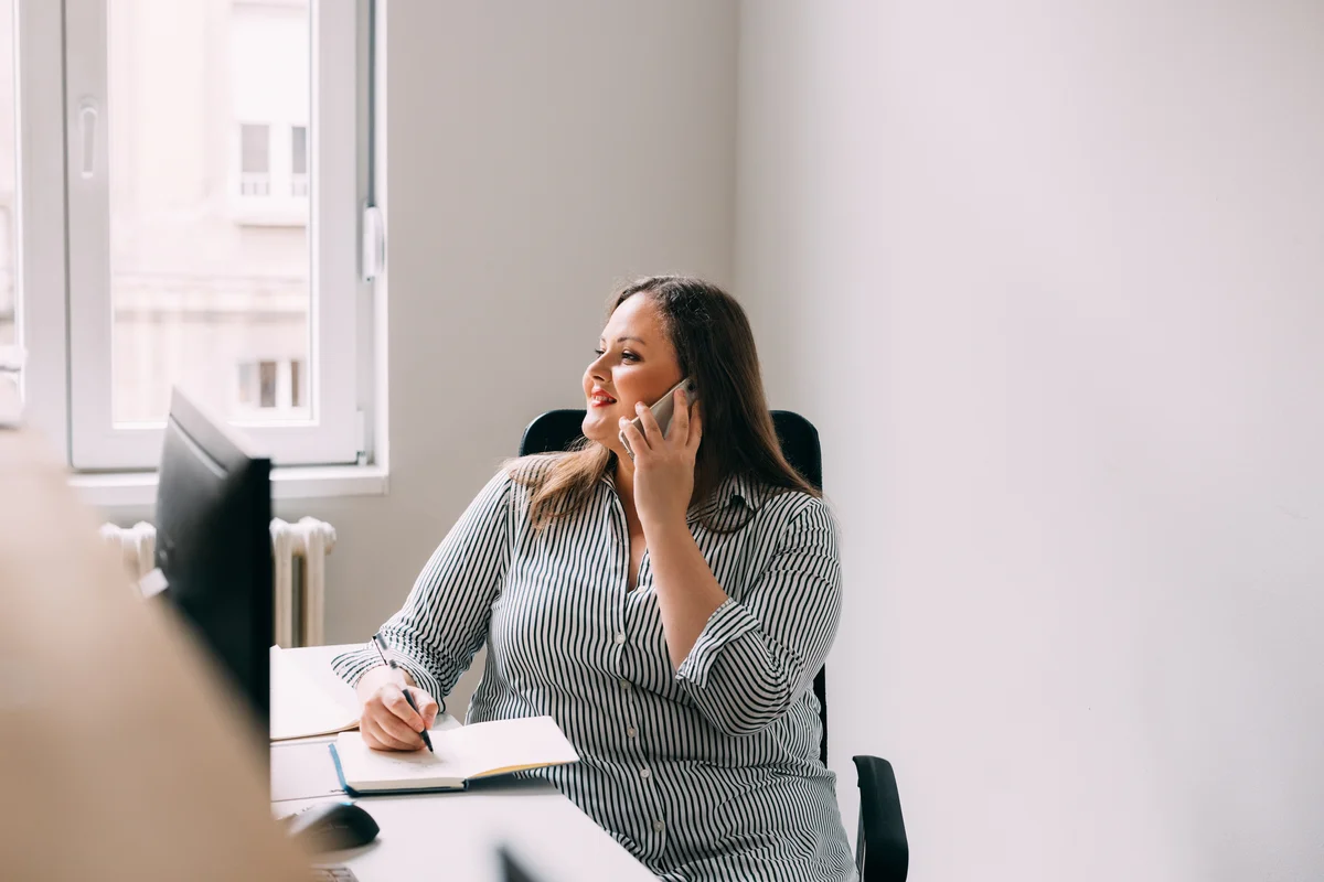 Woman drawing while talking on the phone
