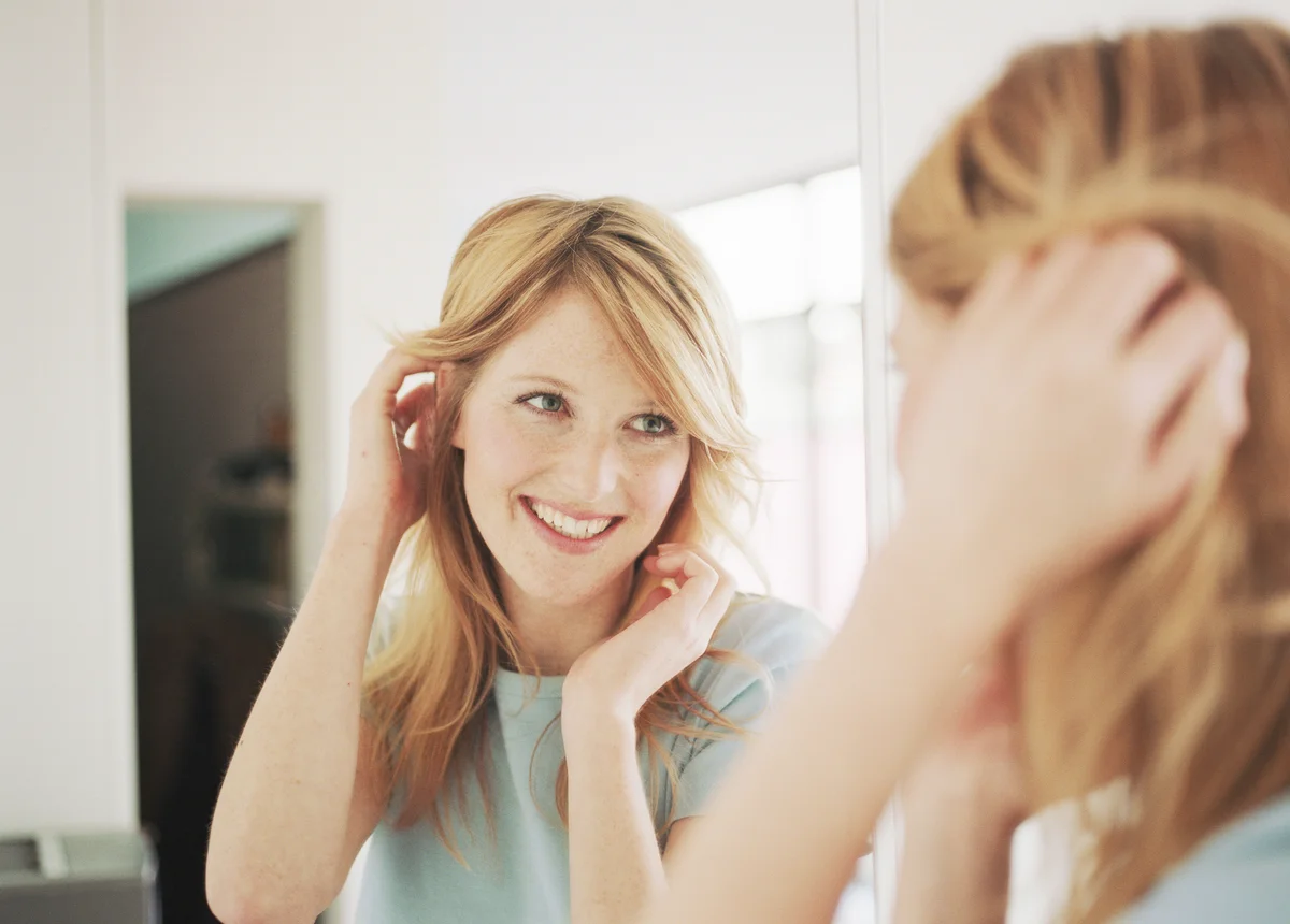 Woman staring at herself in mirror