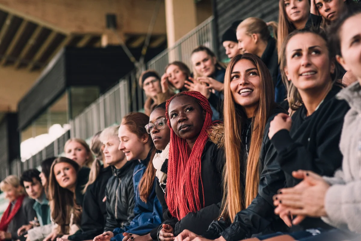 spectators looking away while sitting in stadium during soccer match