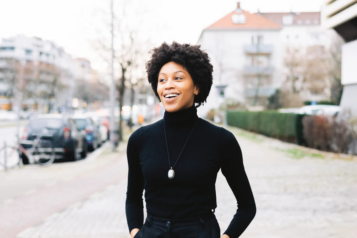 Woman walking down the street wearing all black clothes