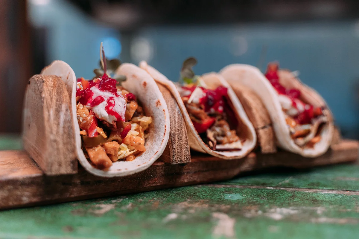 tacos prepared to serve on a wooden stand