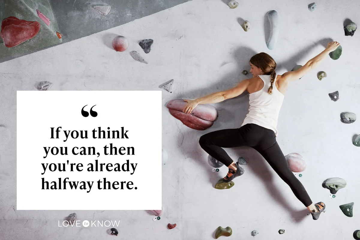Female climber scaling climbing wall