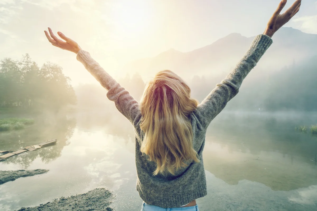 Young woman feeling strong and free in nature