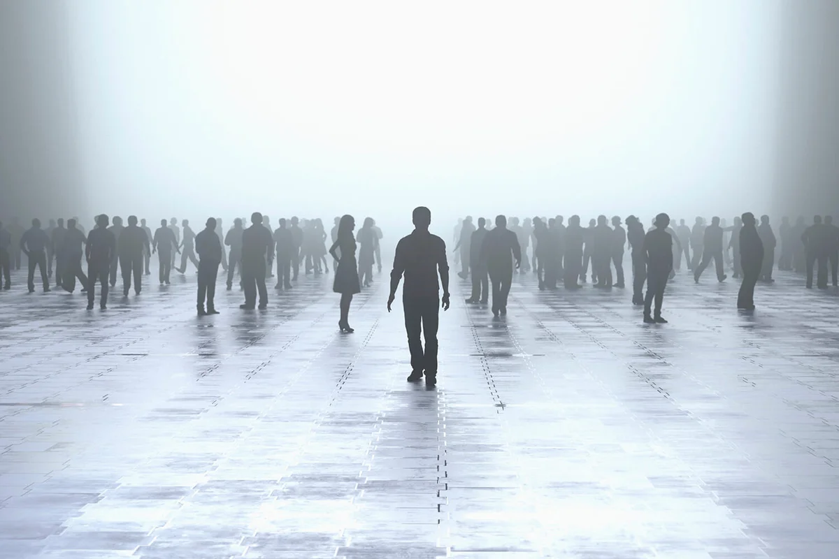 Silhouette of man standing out from the crowd
