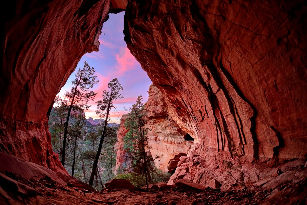 Trees And Sky Seen Through Cave During Sunset