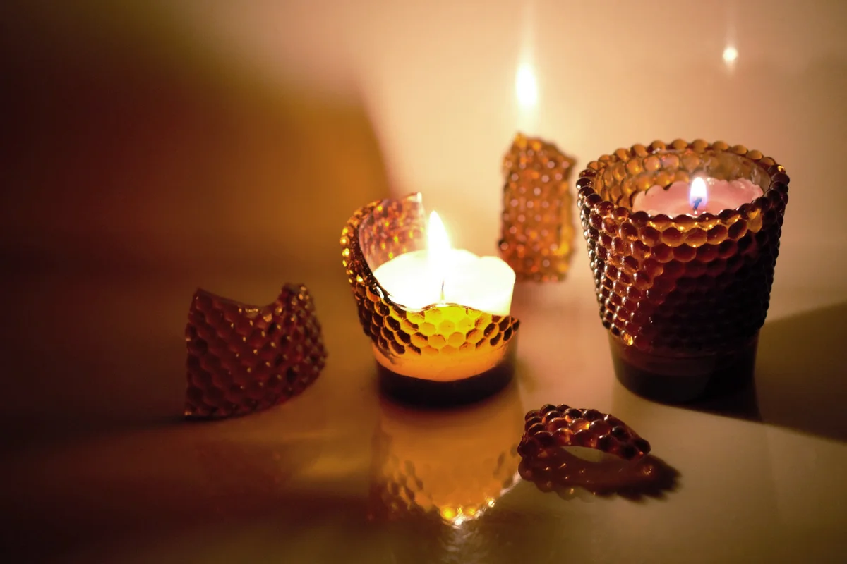 Broken candle jar with beautiful lights and reflections