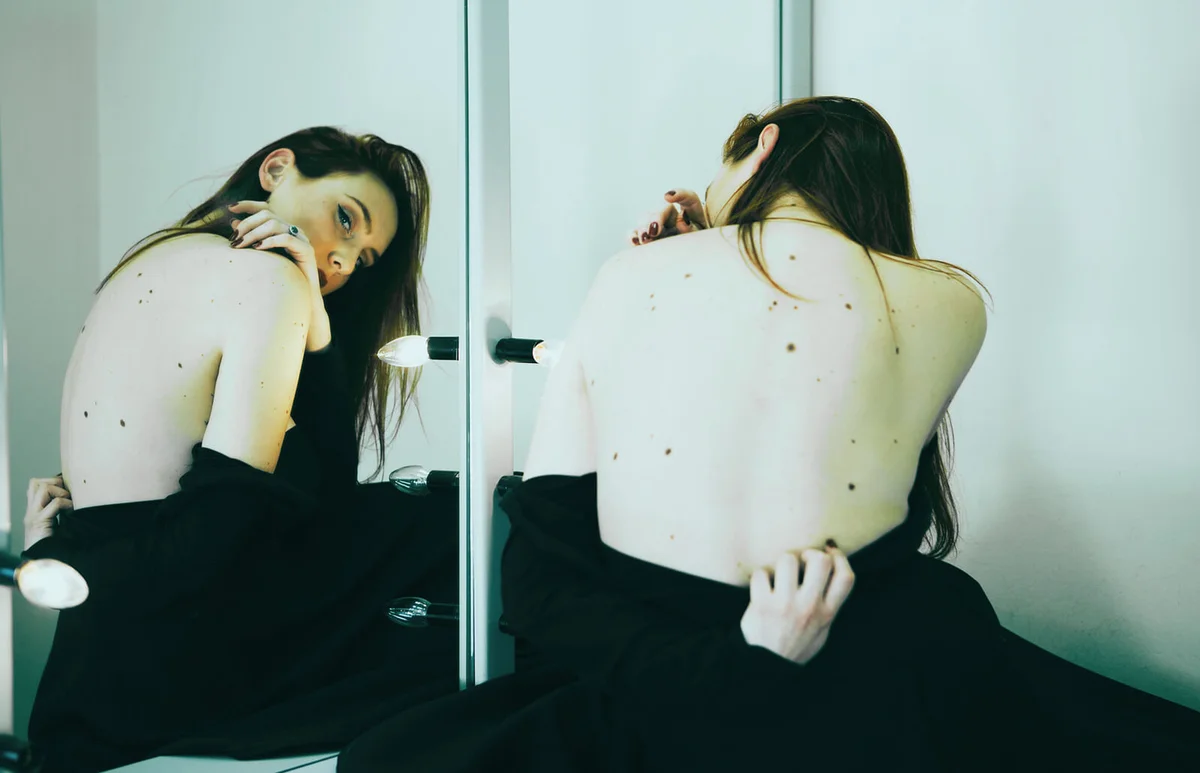 Reflection Of Woman In Mirror