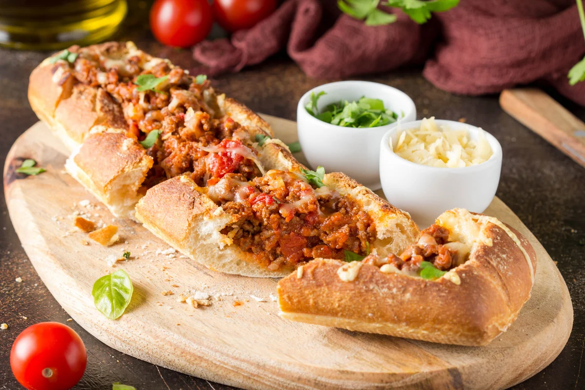 Baguette stuffed with bolognese ragout of minced beef, tomatoes and cheese
