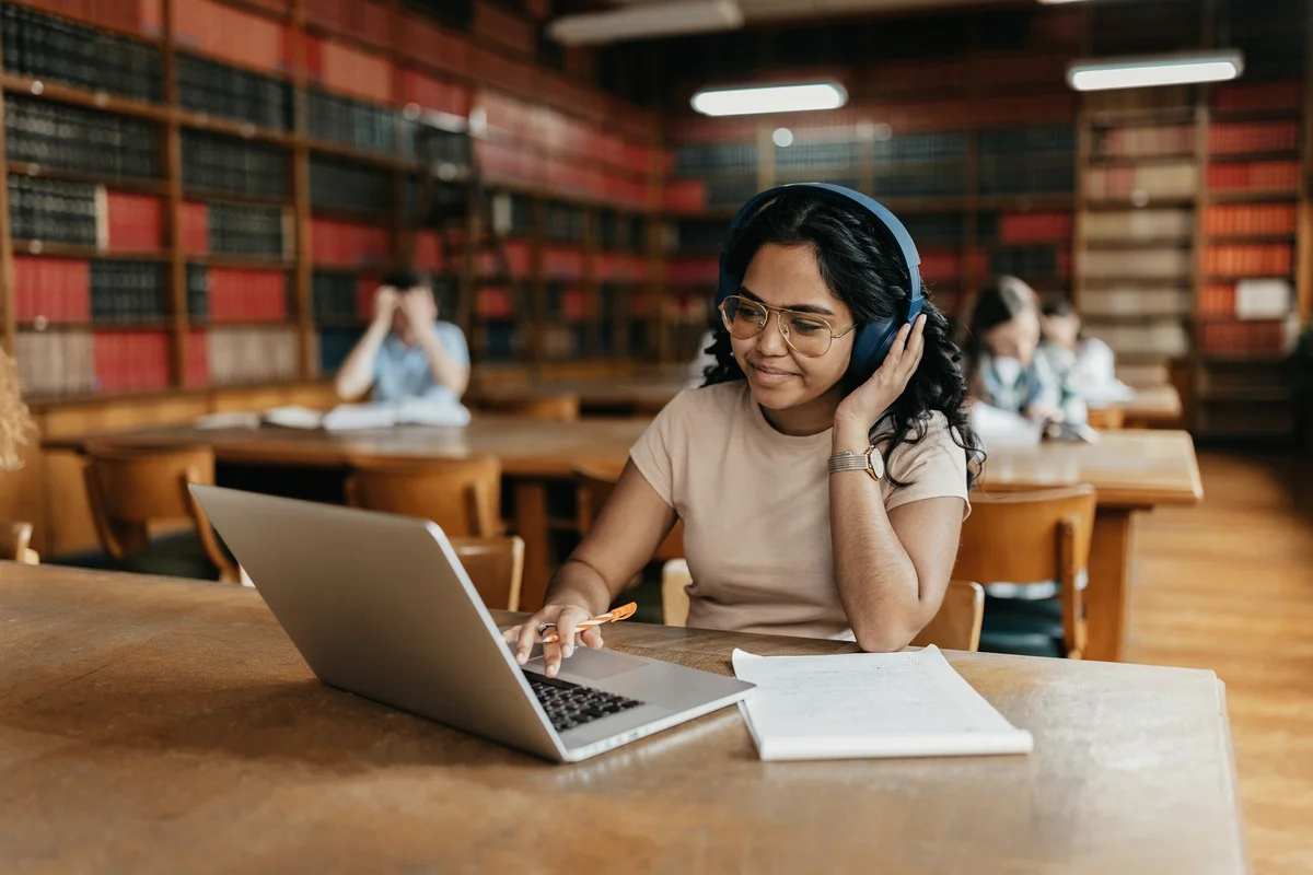 Female student working on the laptop in the university library