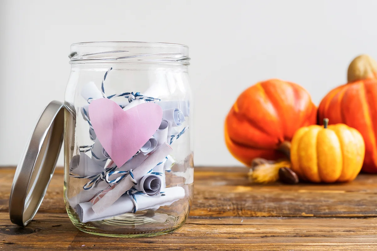 Jar with pink heart and rolled-up notepads