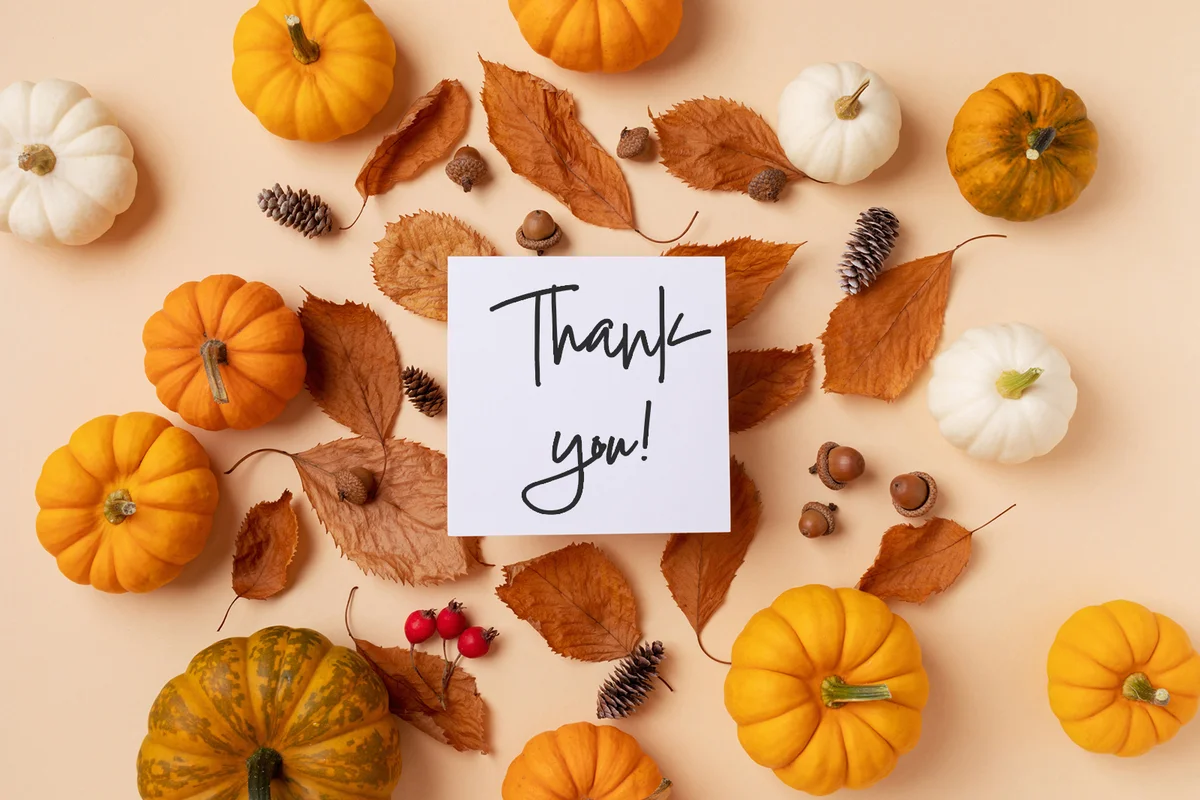 Happy Thanksgiving holiday background with paper note from autumn foliage