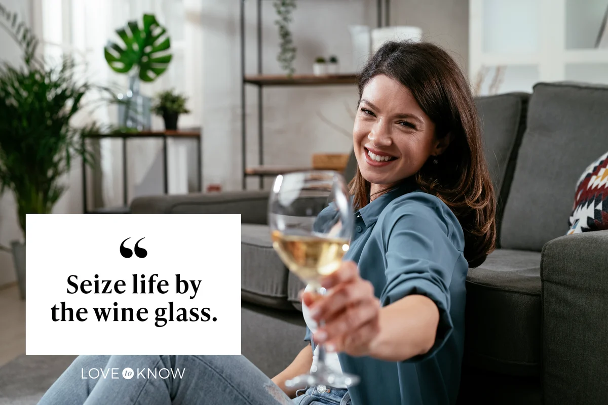 Young woman enjoying at home and drinking wine