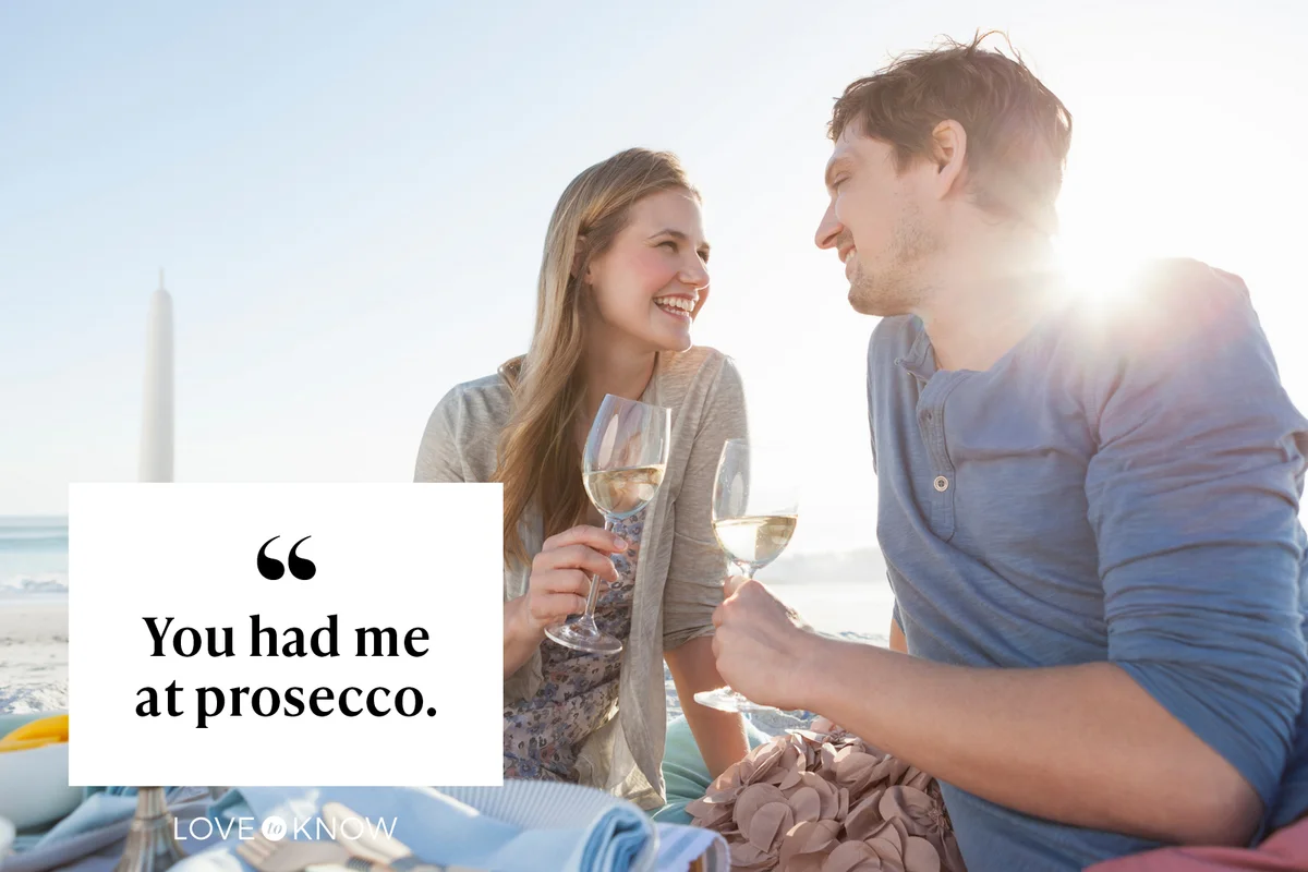 Couple having picnic on beach with wine