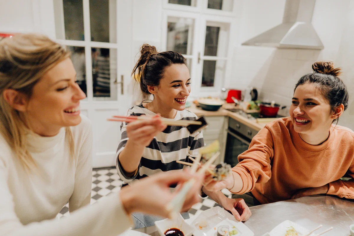 Girls having dinner together at home