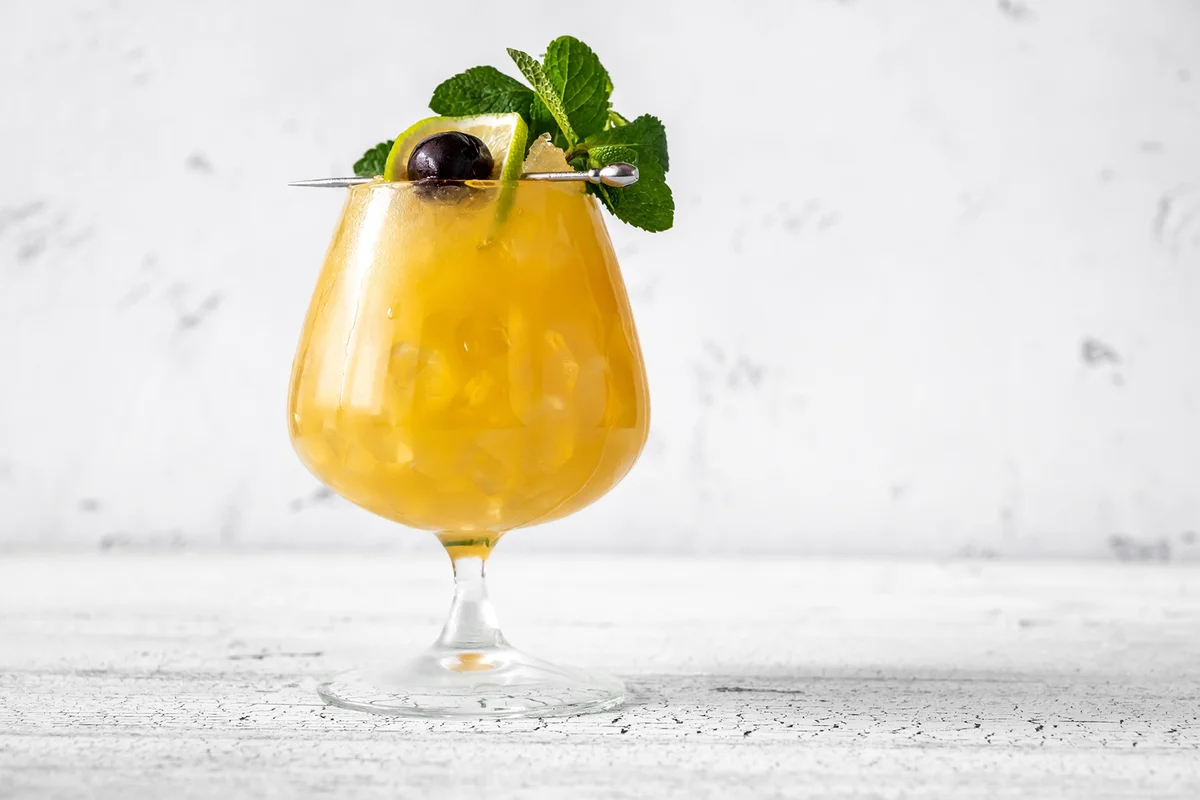 Glass of quarantine order cocktail garnished with mint