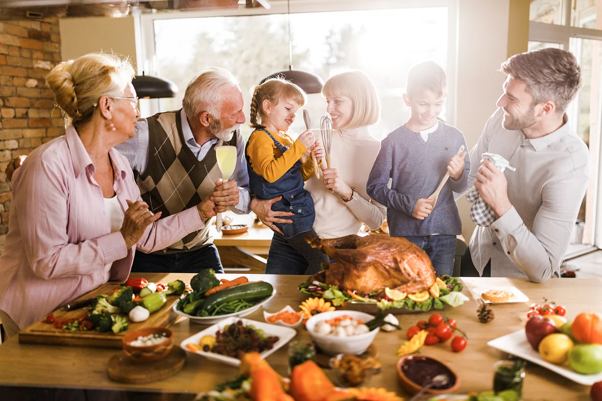 Happy extended family talking on Thanksgiving day