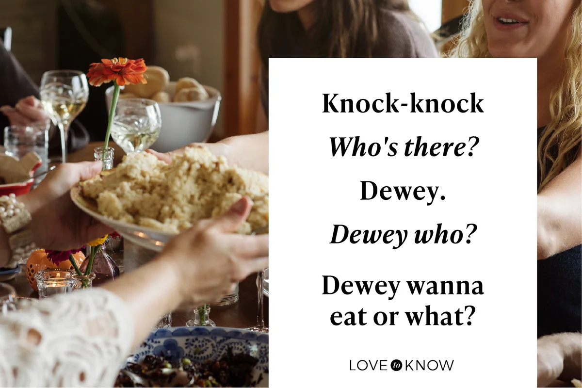 Women passing food while sitting at dining table during Thanksgiving