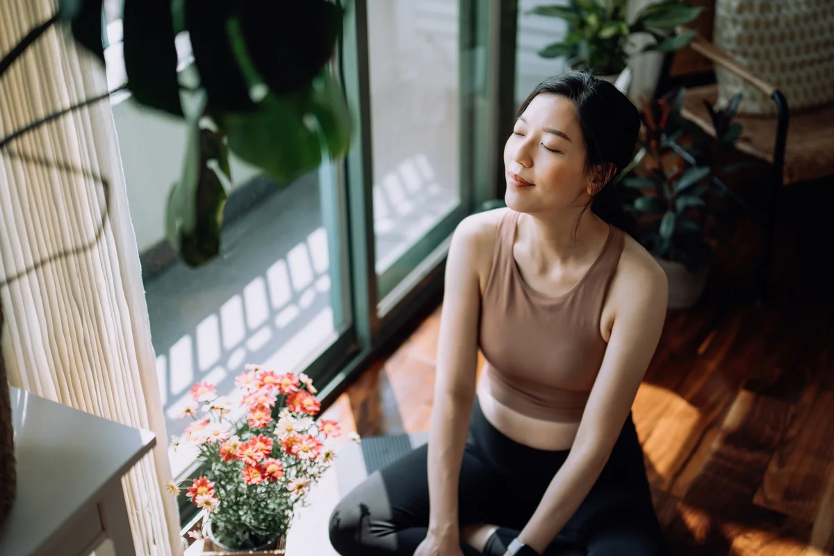 Woman sunbathing in her home