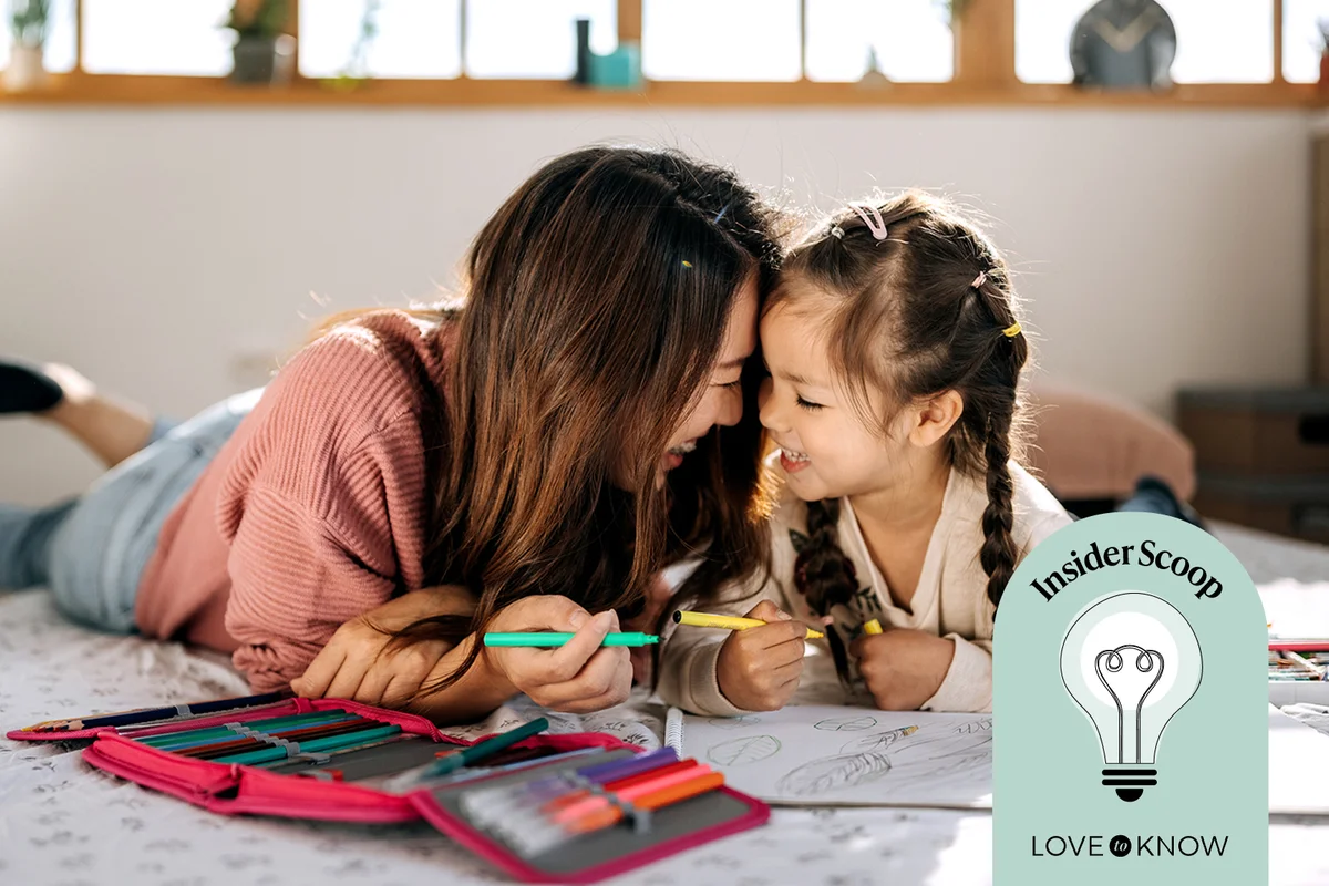 Mother and daughter bonding while drawing in their cozy bedroom