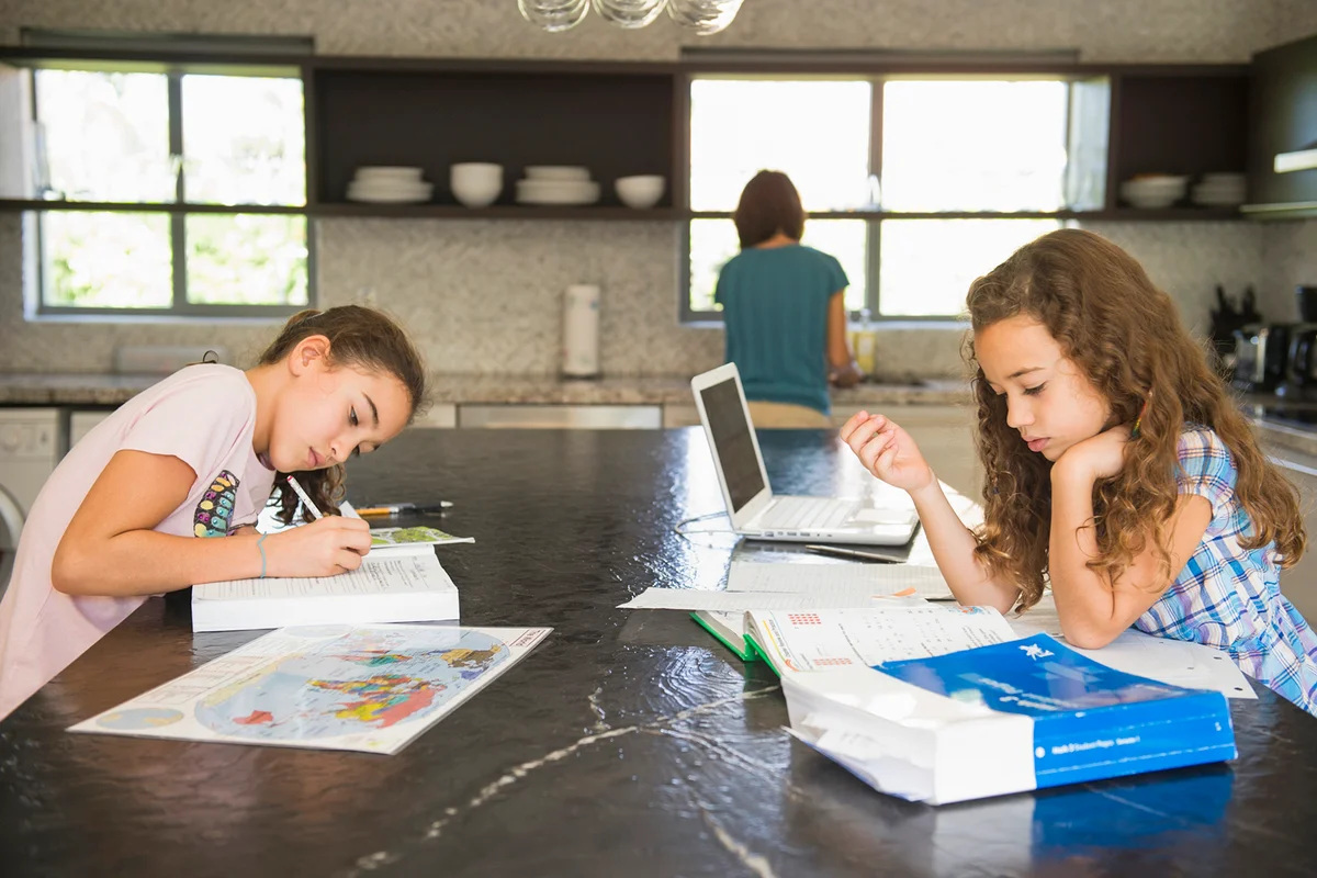 Girls studying in kitchen