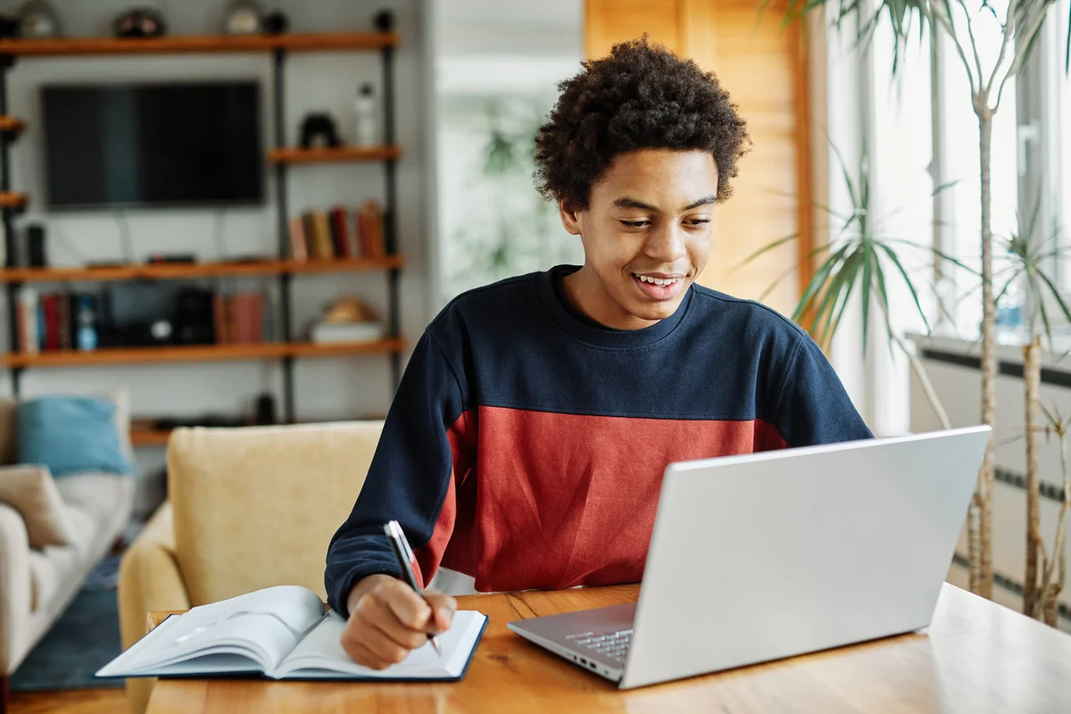 boy using laptop computer at home