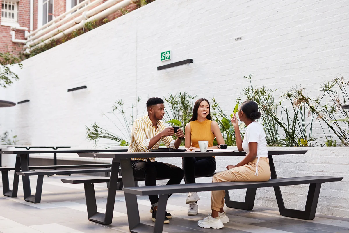 young businesspeople having a meeting outside of an office