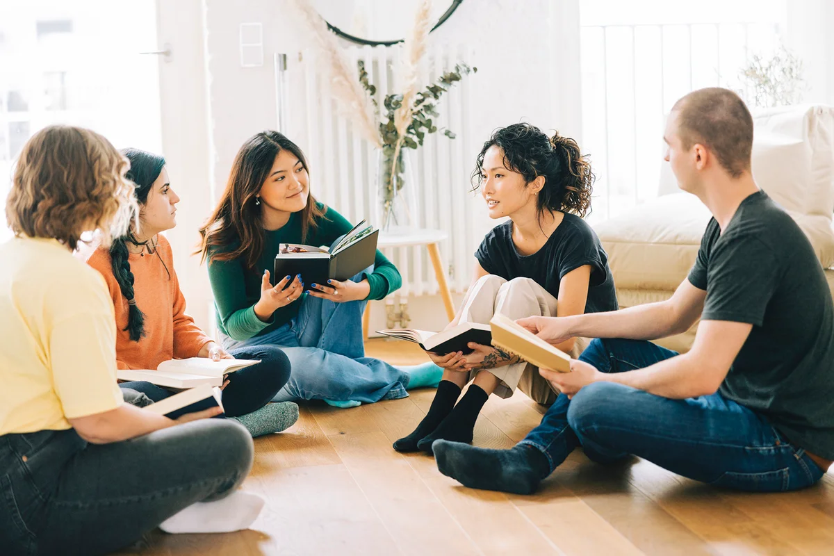 Happy people discussing a new book