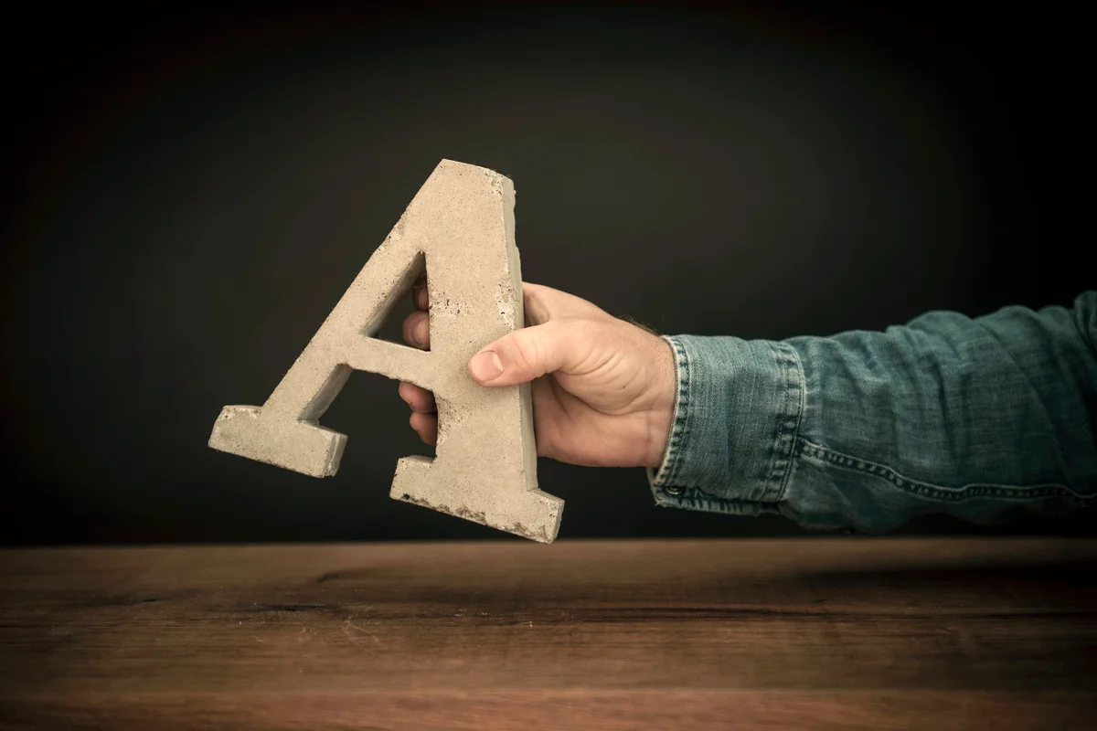 Man holding the letter A