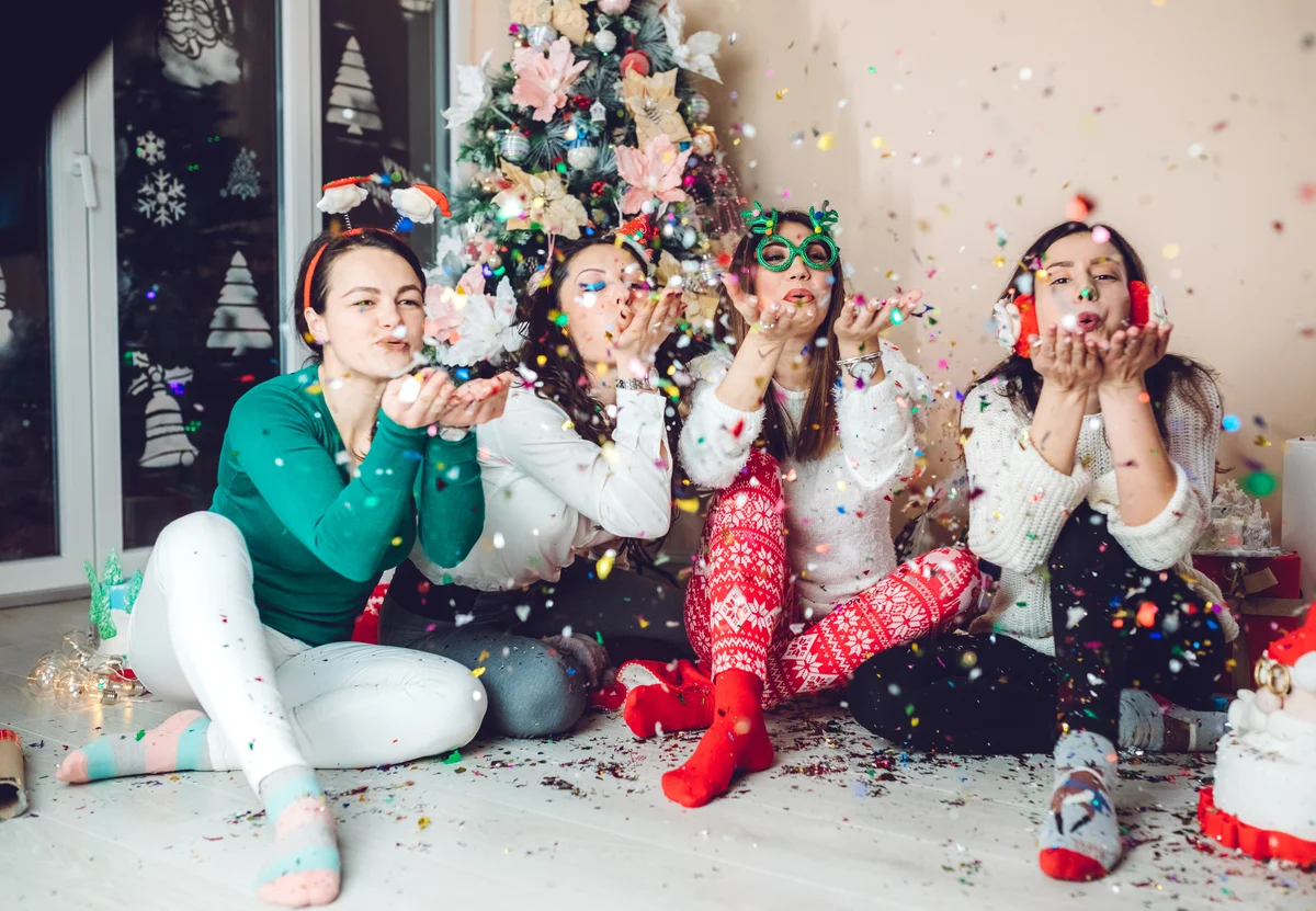 friends in jammies by the Christmas tree