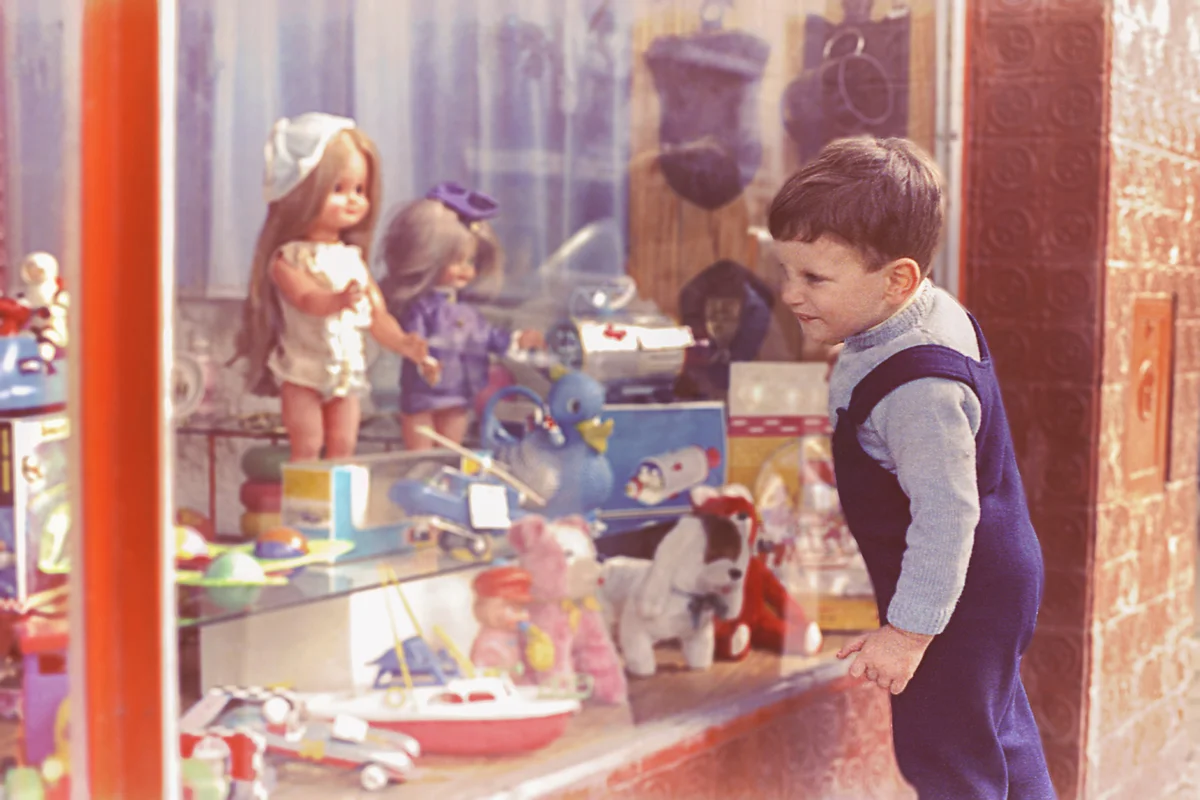 Vintage kid looking at a toy's shop