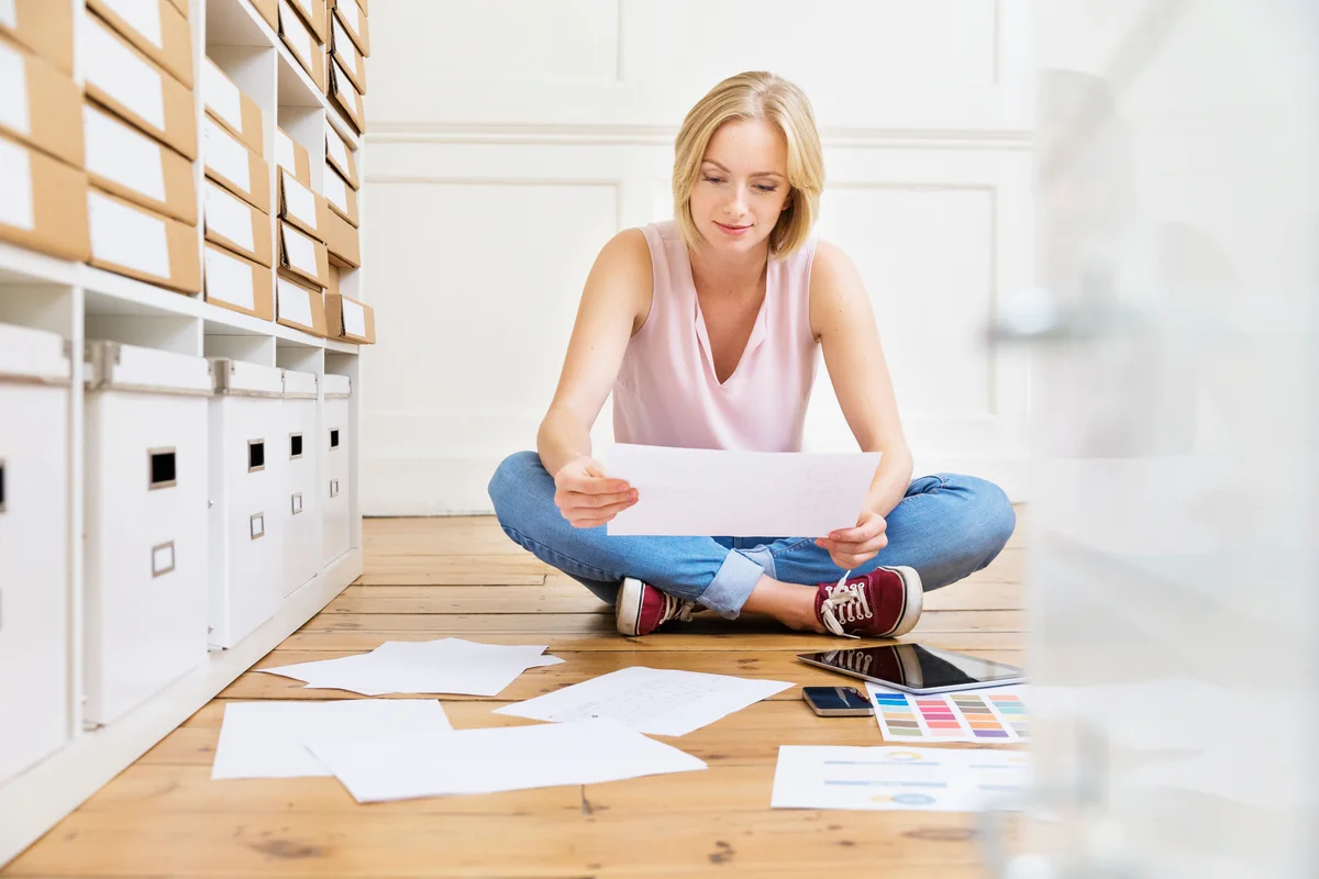 Womansitting on floor creating mood board
