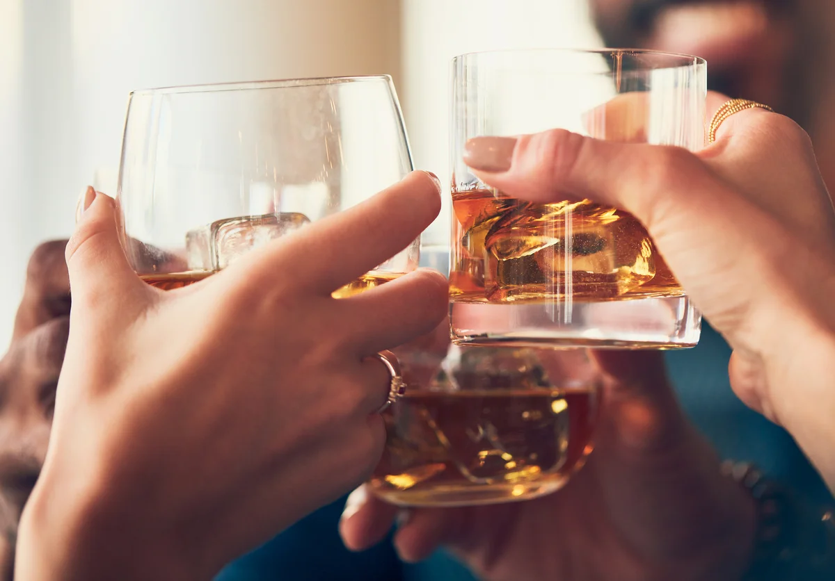 Friends cheering with whiskey
