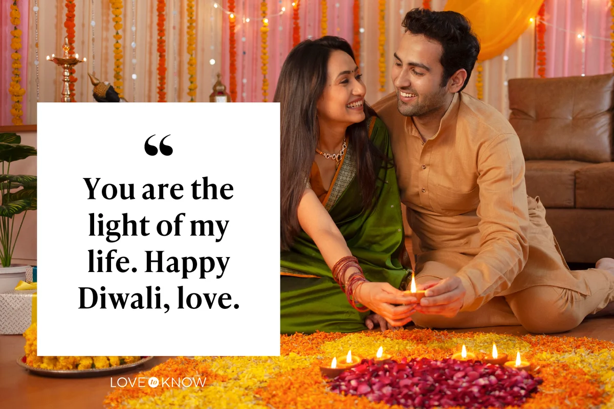 couple looking at each other placing diyas on rangoli for Diwali
