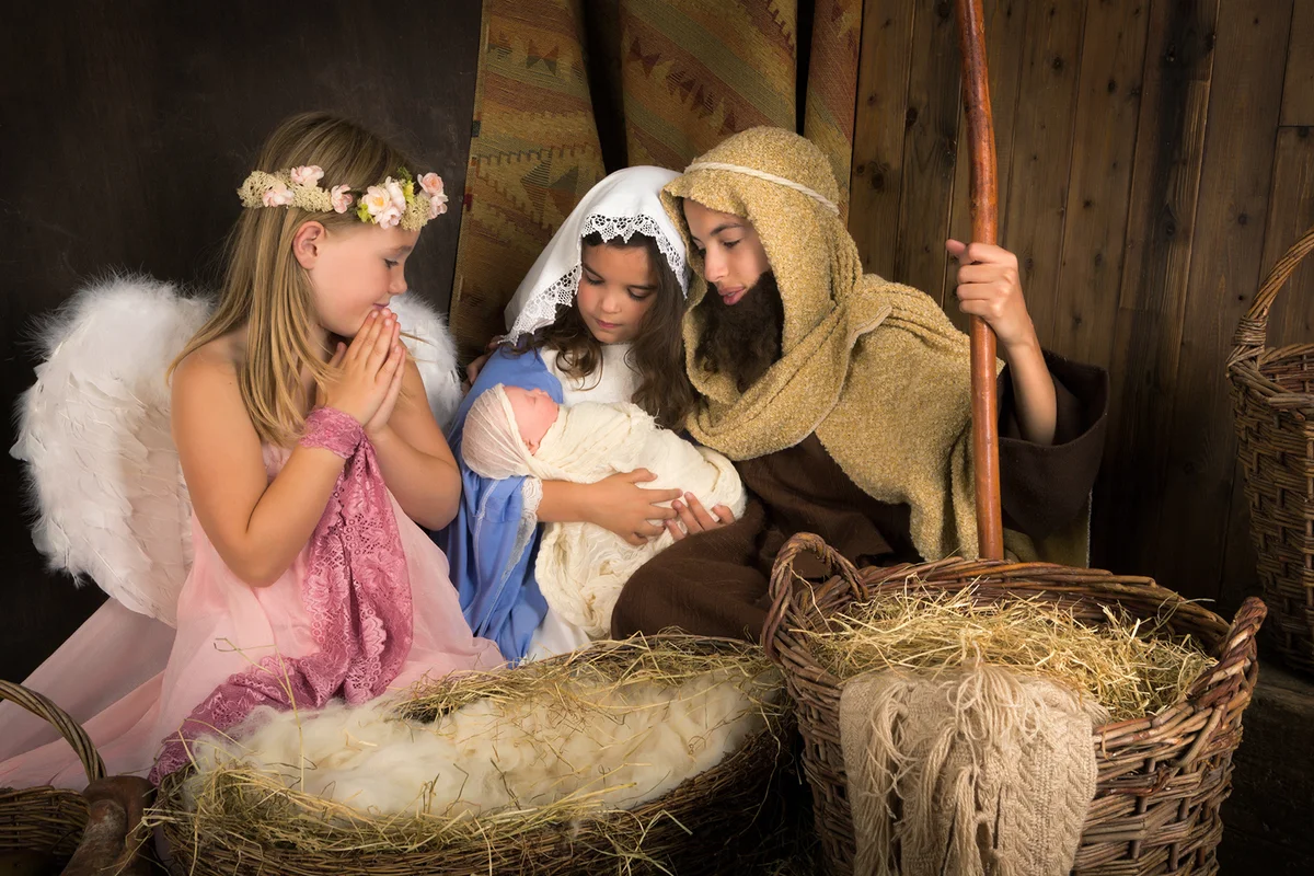Kids representing Christmas nativity with angel