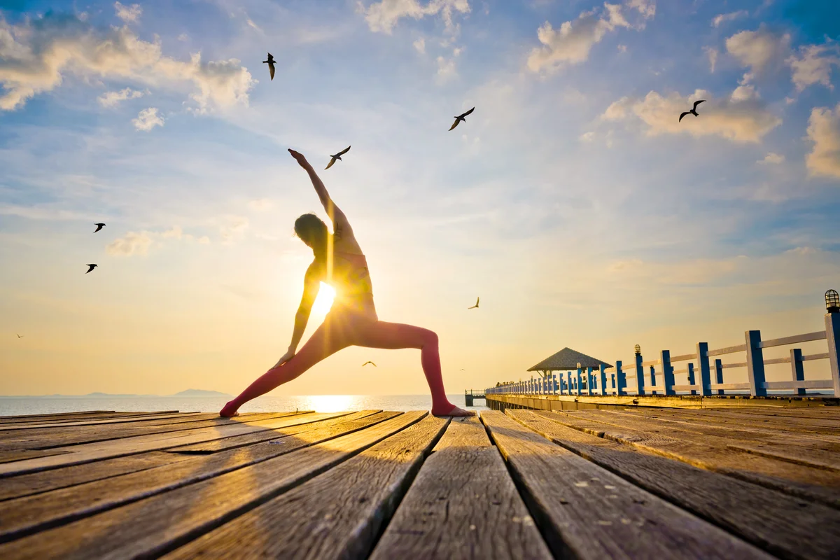 Woman doing yoga on bridge