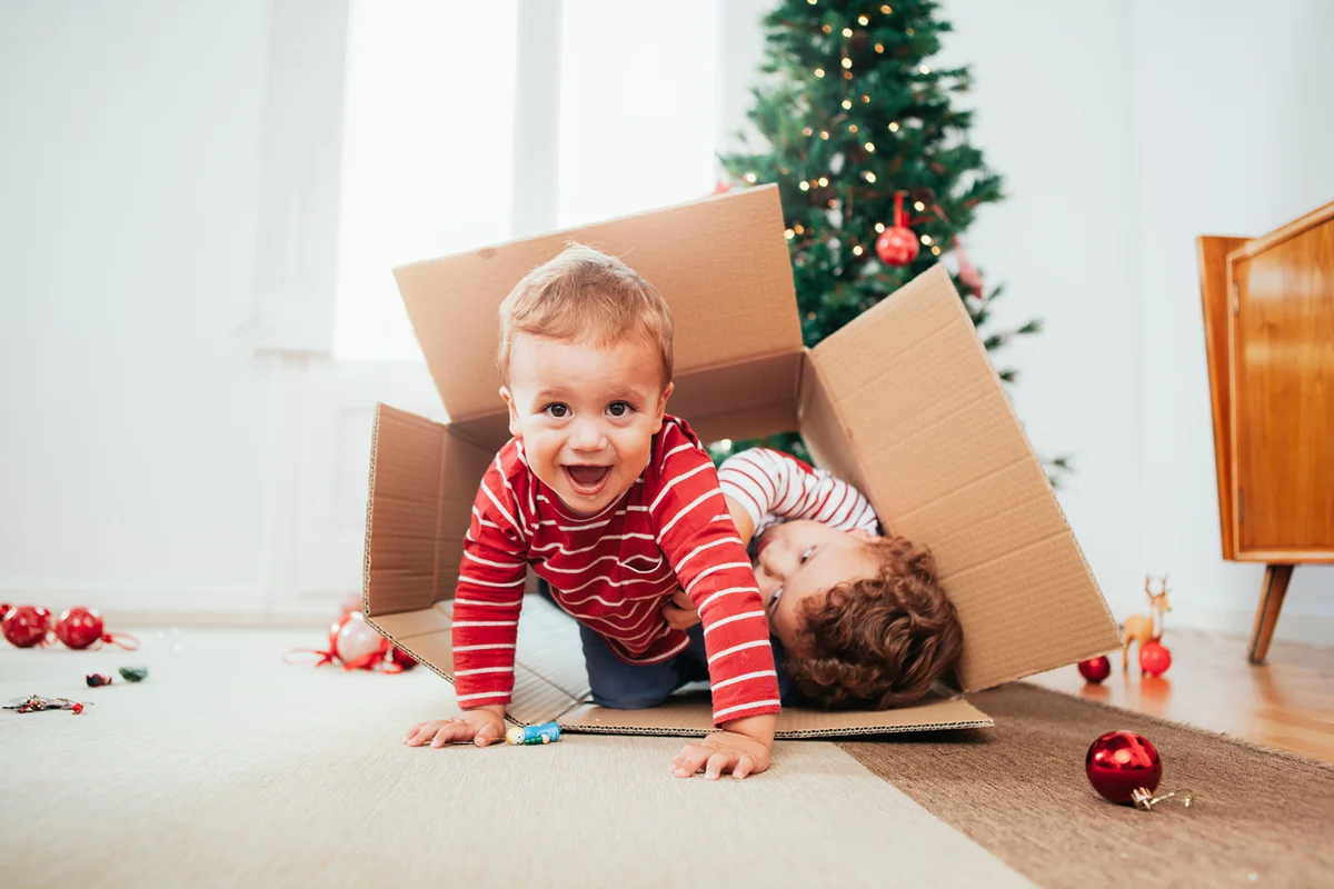 Siblings decorating the Christmas tree