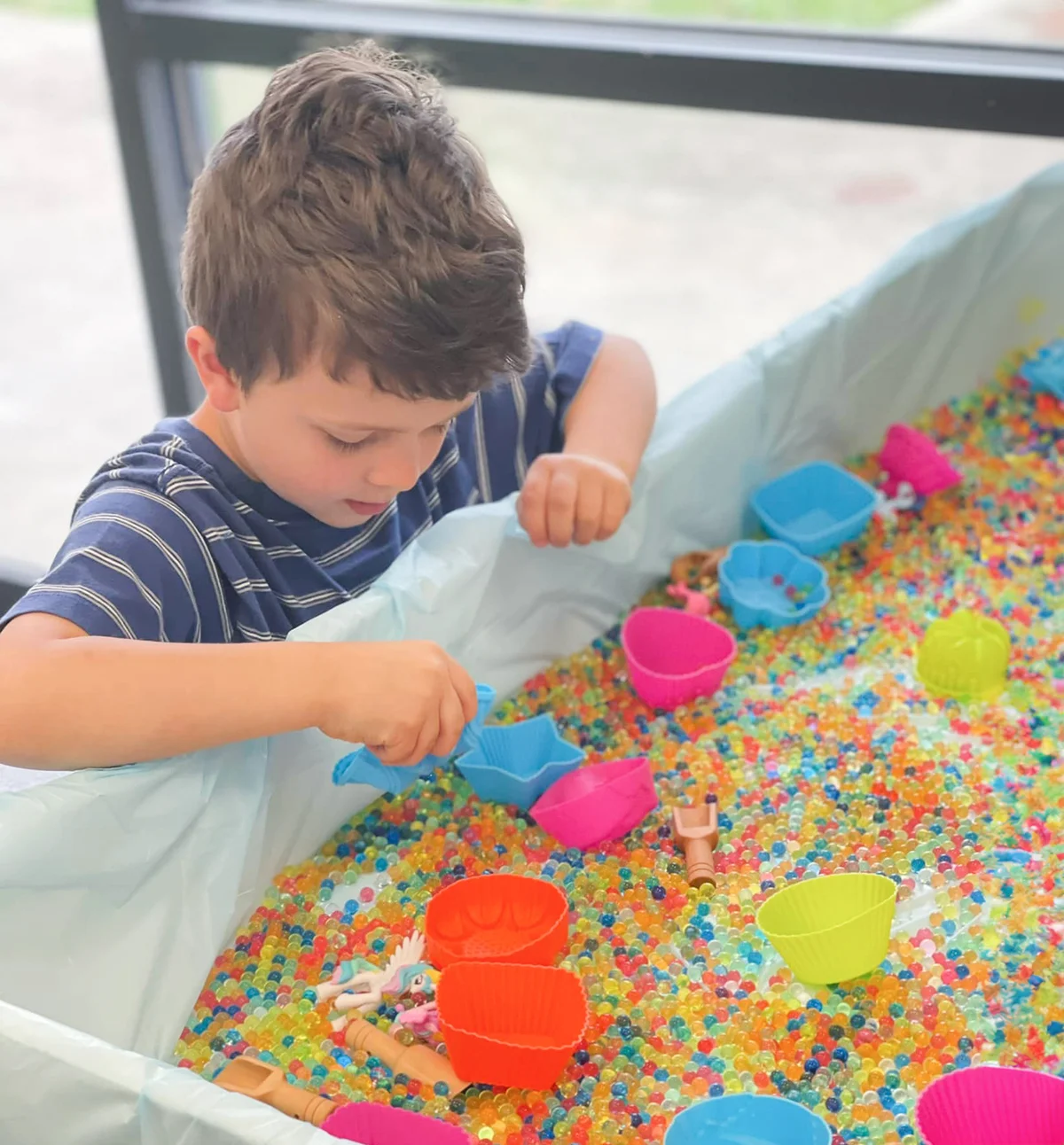 Child playing in sensory bin