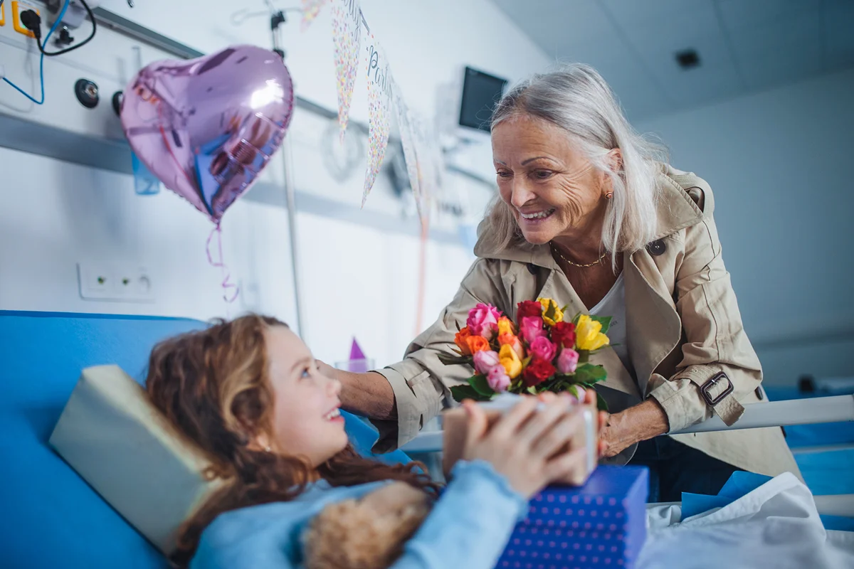 Granmother visiting her sick granddaughter in hospital