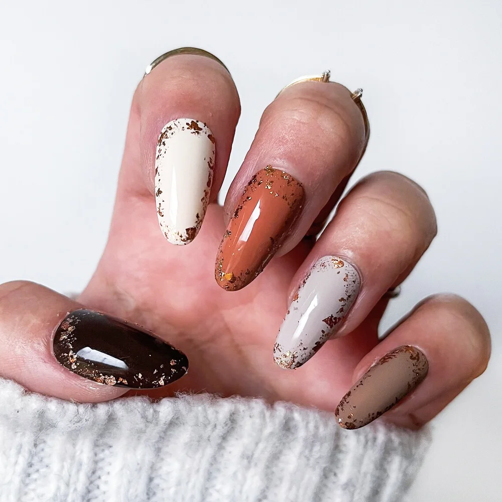 Matte neutral brown coloured set of nails with bronze foil