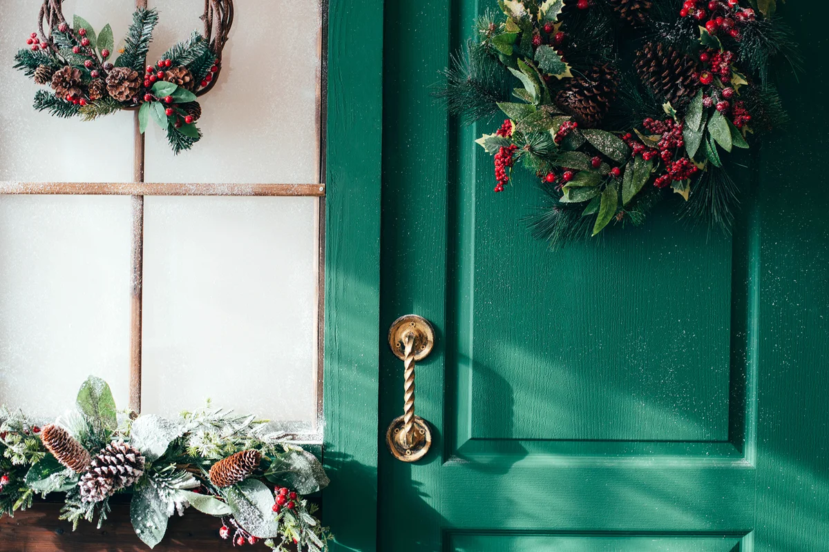 Porch with wooden doors and a threshold with Christmas decor