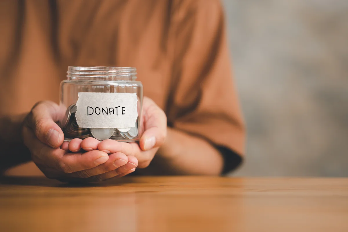 Man holding money jar
