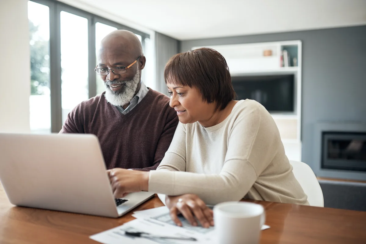 Cropped shot of a happy senior couple using a laptop in their living room