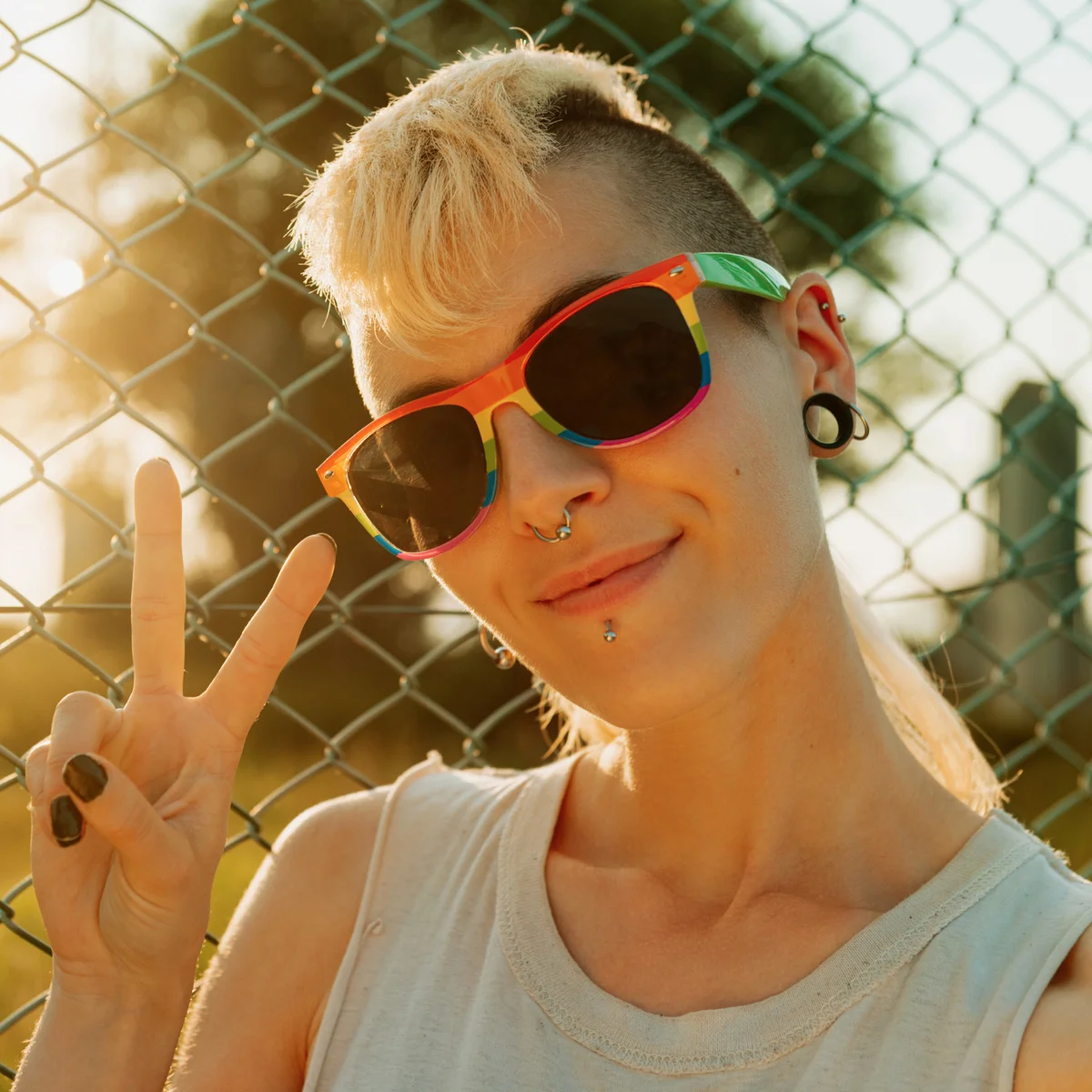Non-binary person making the victory symbol