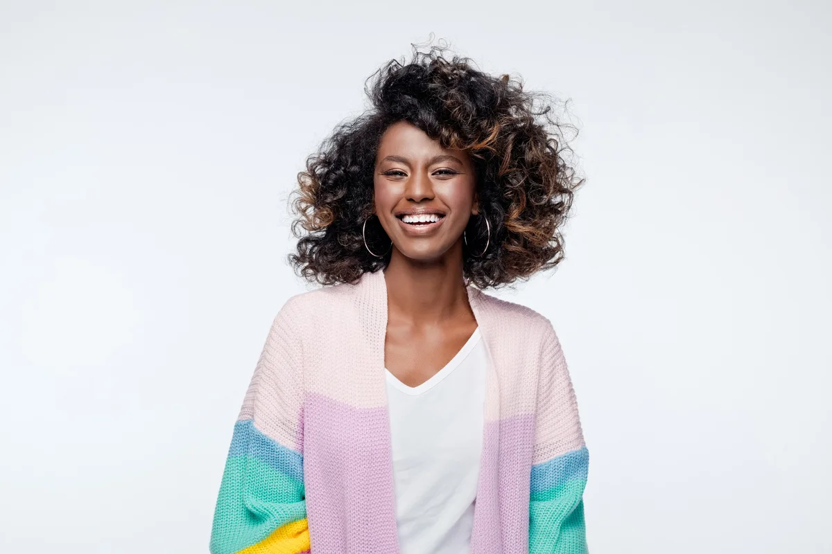Excited woman wearing rainbow cardigan
