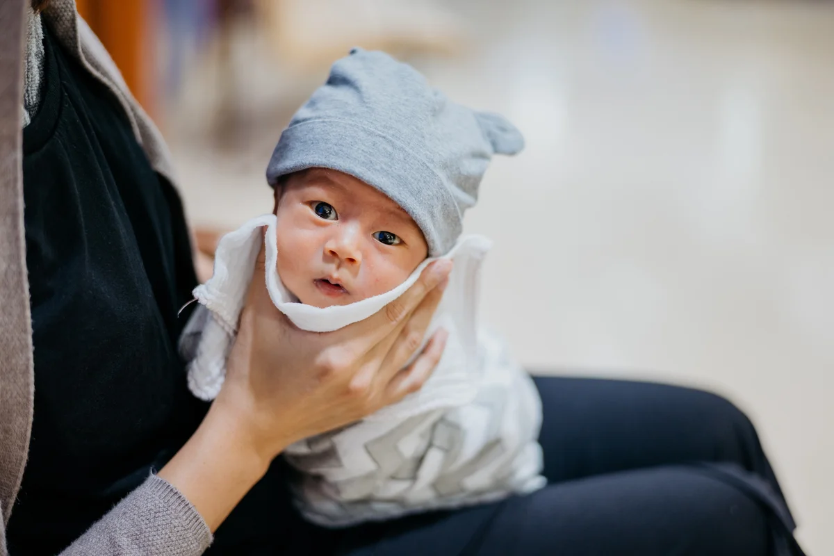 Mother burping baby after feeding