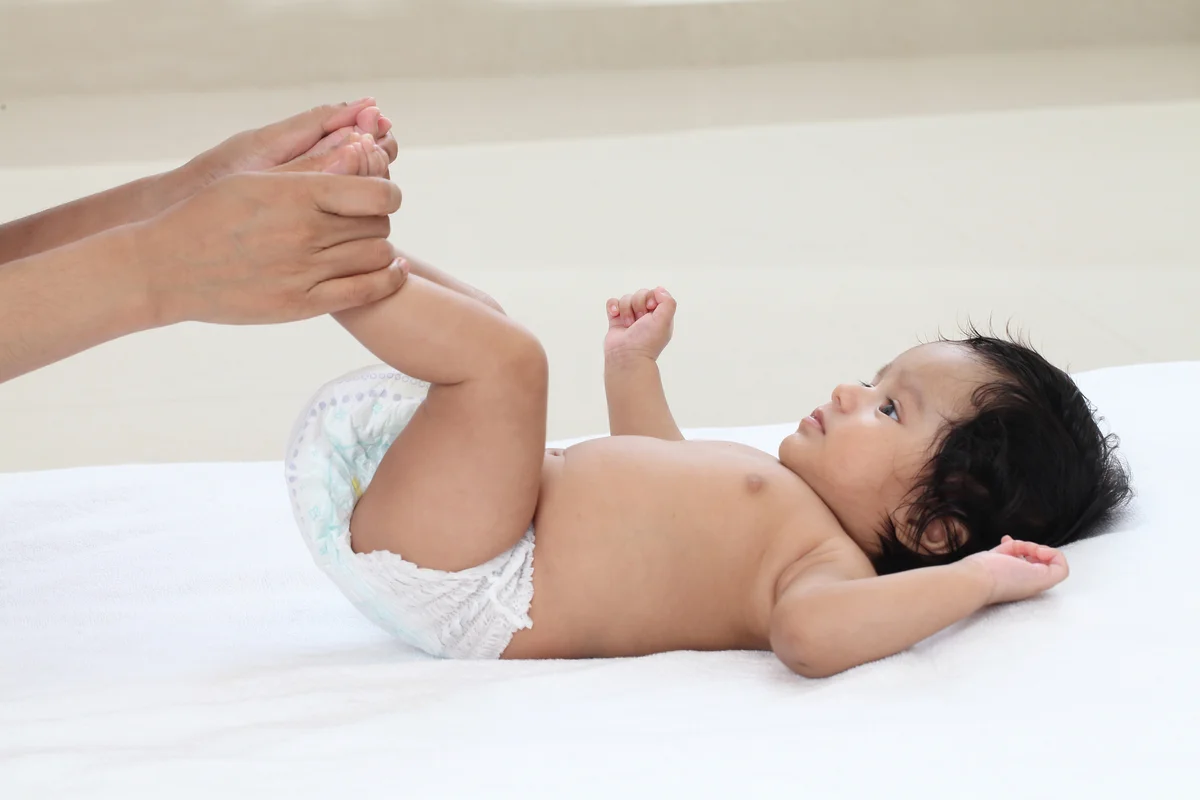 Massaging baby boy feet