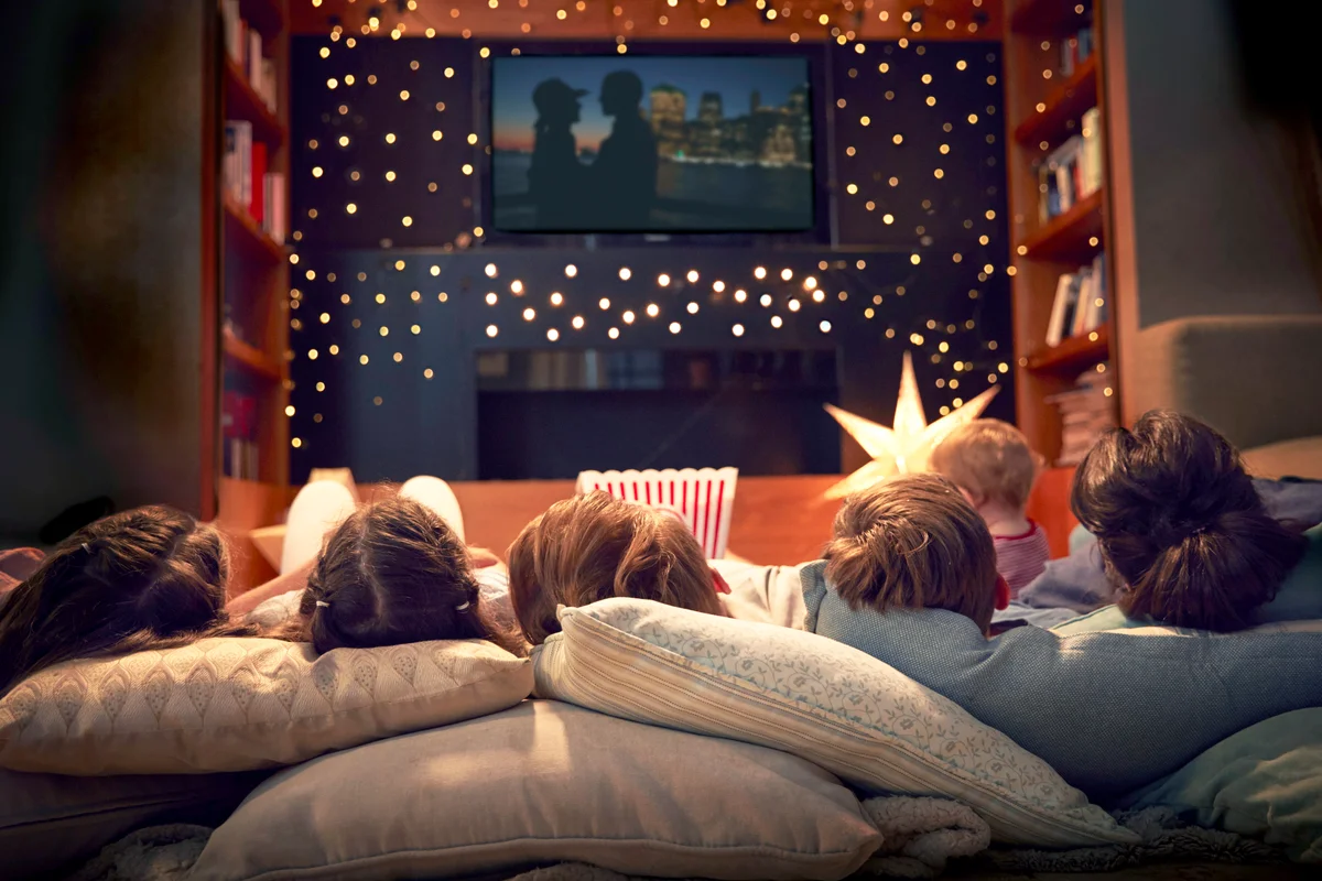 Family Enjoying Movie Night At Home Together