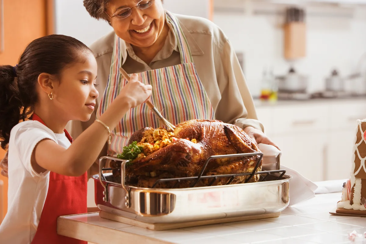 grandmother and child making turkey and stuffing